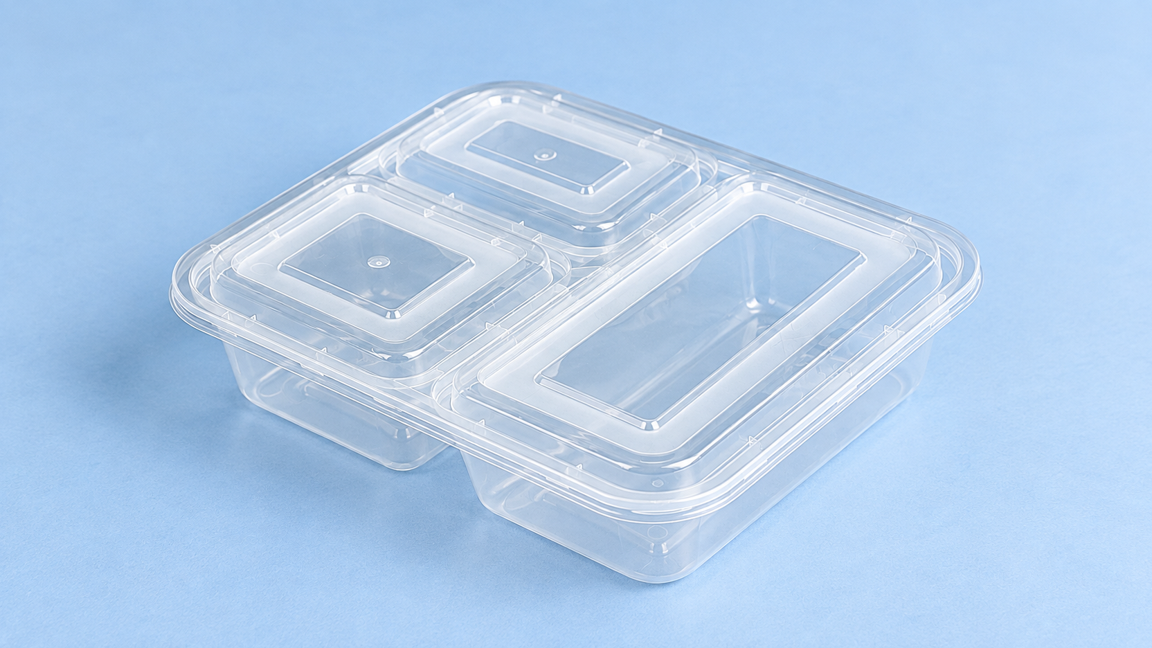 Clear three-compartment meal-prep container with fitted lids.