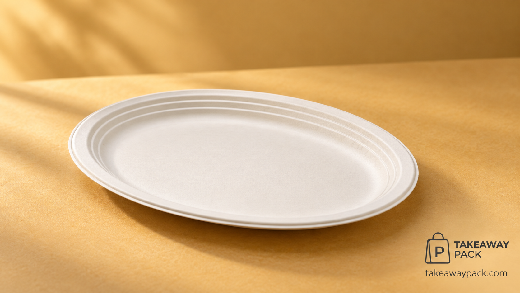 Empty off-white oval moulded-fibre disposable plate with a ridged rim on a warm golden-tan backdrop.