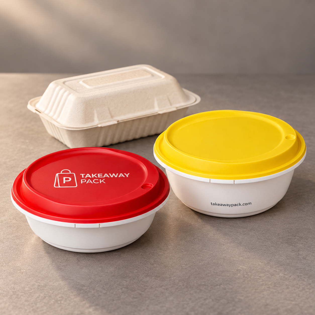 Three takeout containers of different sizes: a white round tub with a red printed lid, a white square box with a yellow printed lid, and a white rectangular box with a white lid.