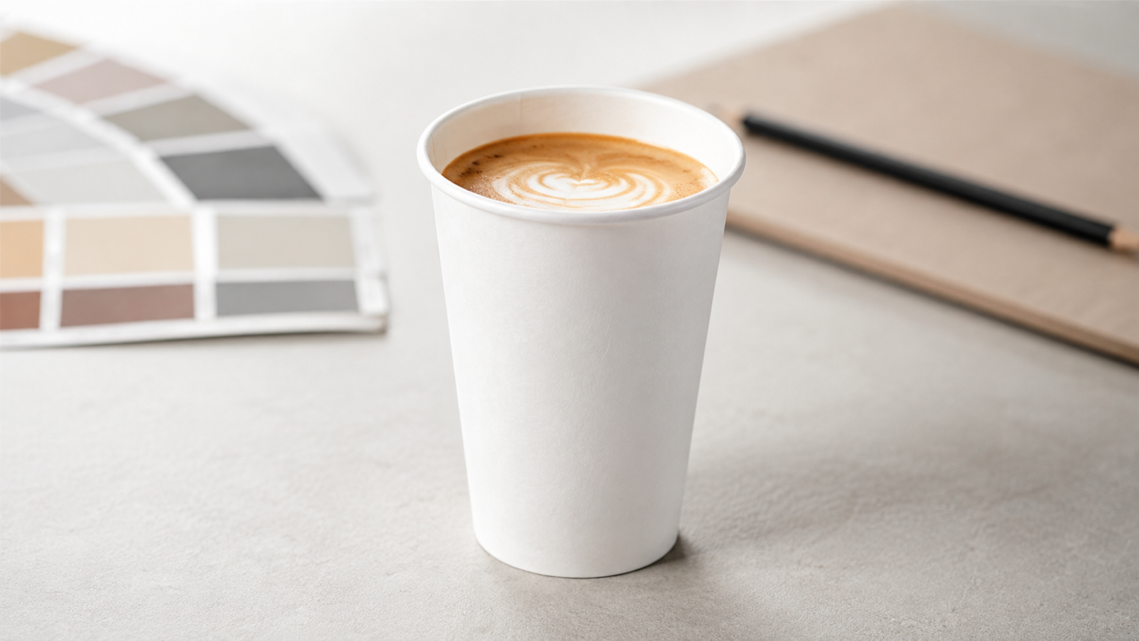 Unprinted white single-wall cup with a latte
