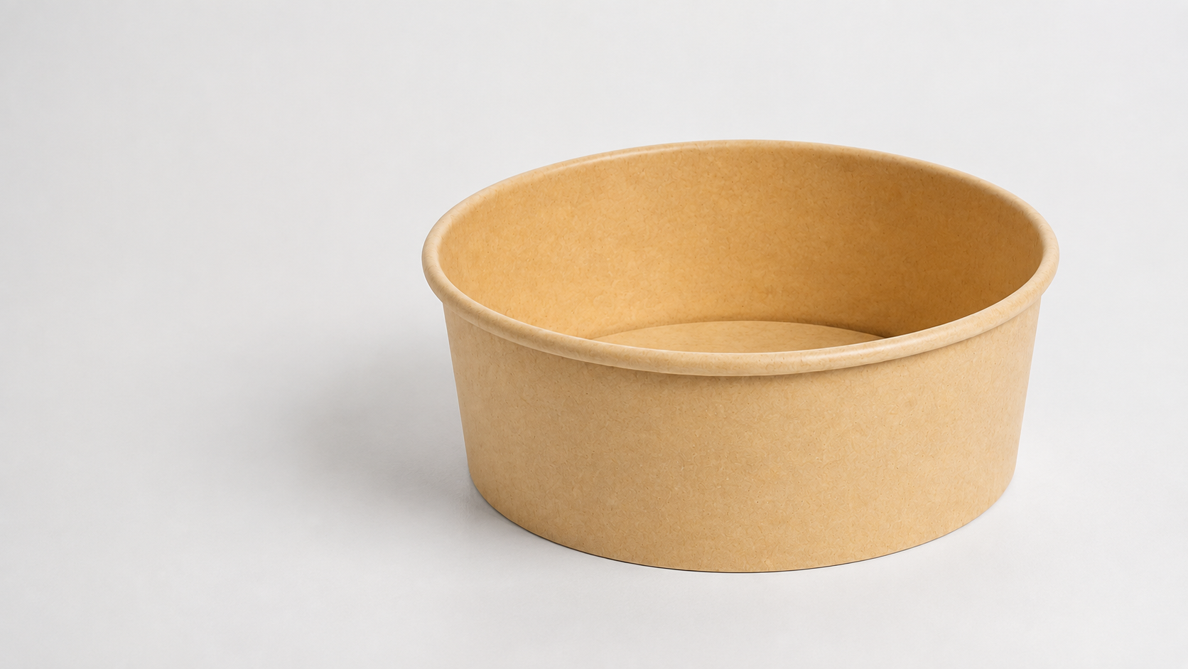 Unbranded natural-kraft paper bowl shown as a factual editorial illustration for foodservice packaging material-change planning.
