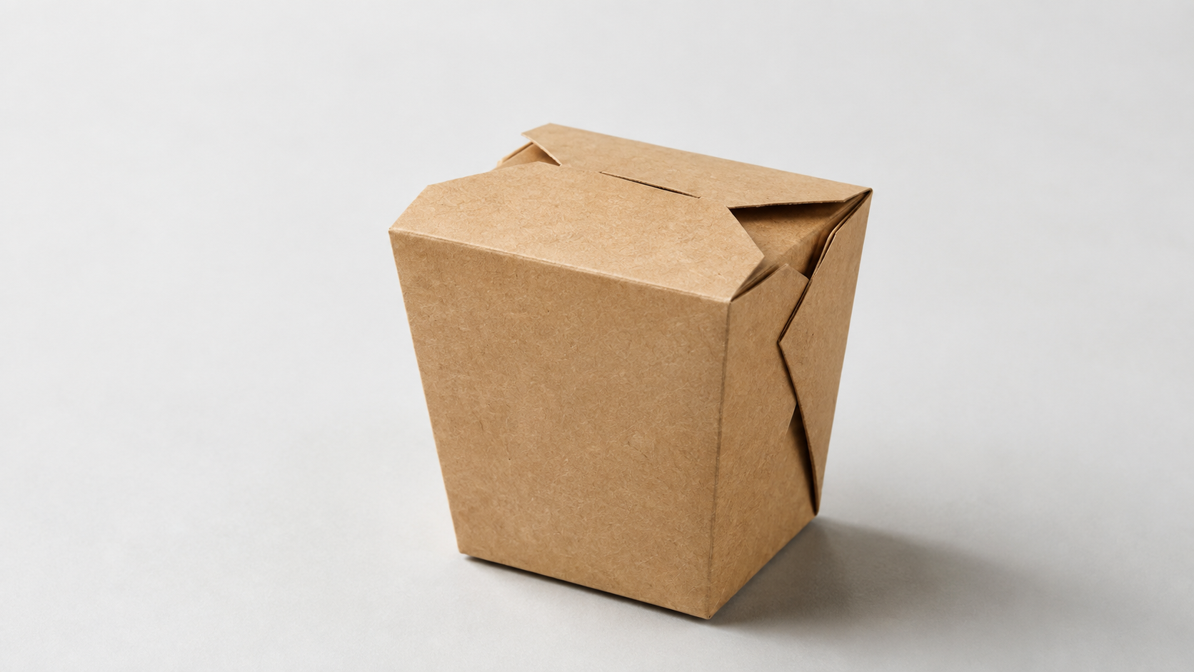 Stack of paper food containers next to a sorting bin
