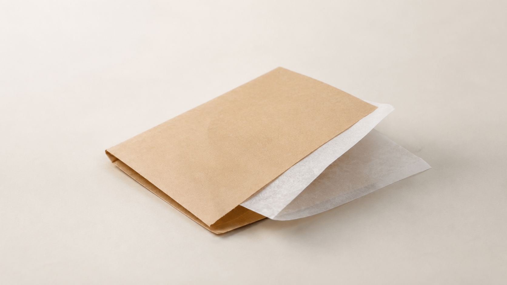 Stack of brown kraft paper bags on a wooden table in a foodservice setting