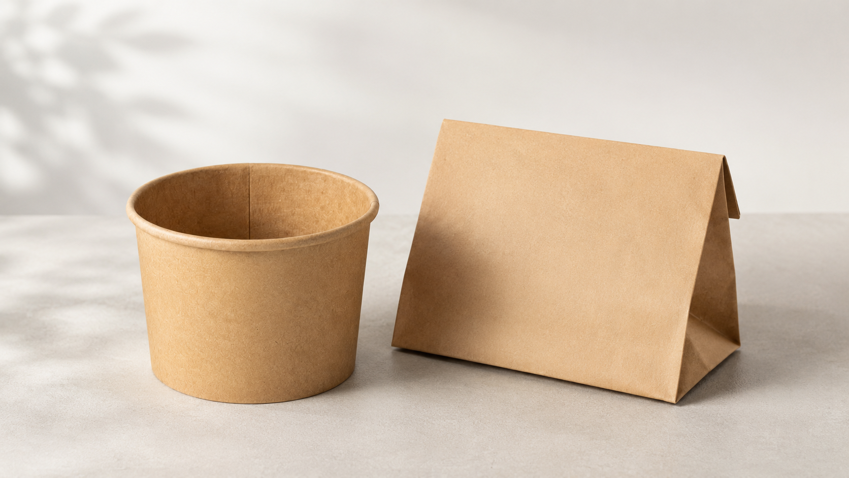 Assorted eco-friendly takeaway containers stacked on a wooden restaurant table