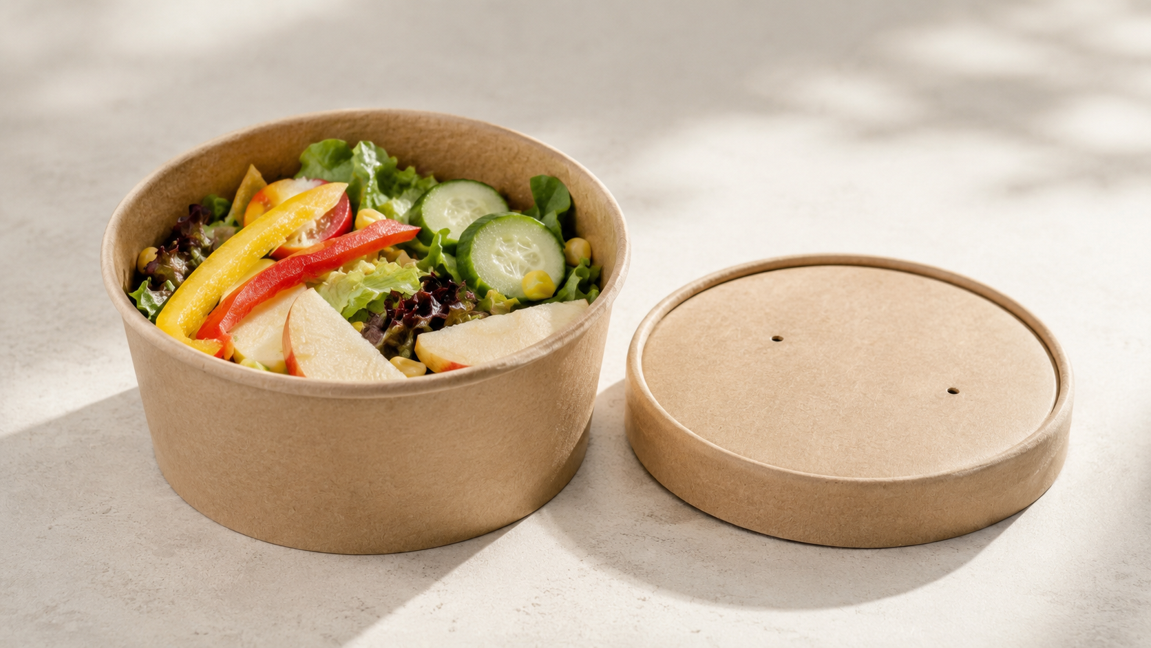 Compostable food containers in various sizes displayed on a kitchen worktop
