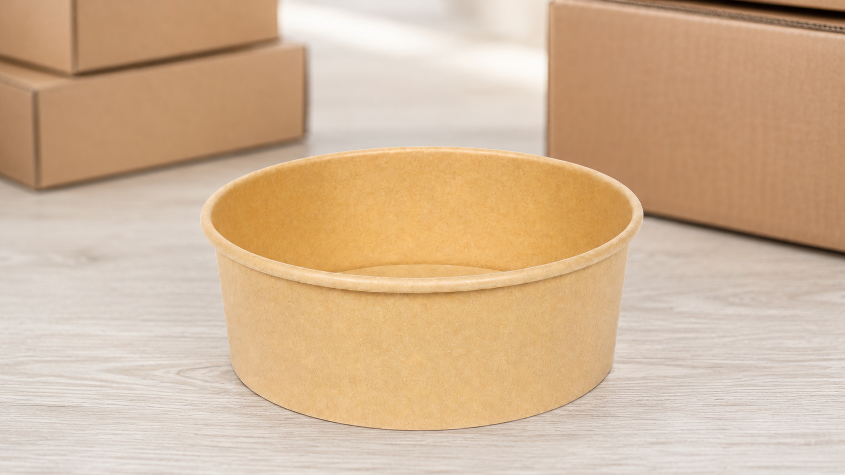 A kraft paper bowl on a dispatch work surface — ordering foodservice packaging depends on specification, cost, and service, not just the unit price.