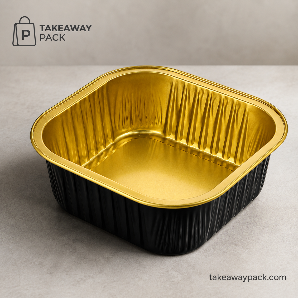 Black-and-gold rectangular aluminium food tray on a light counter