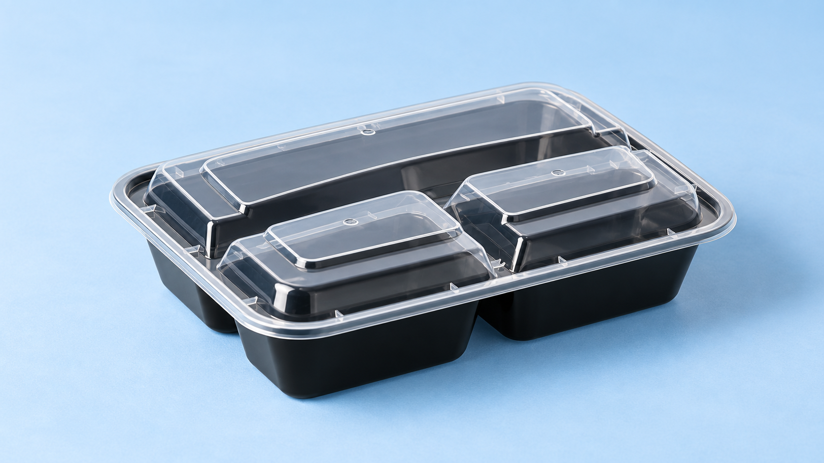 Black four-compartment food container with clear lids.