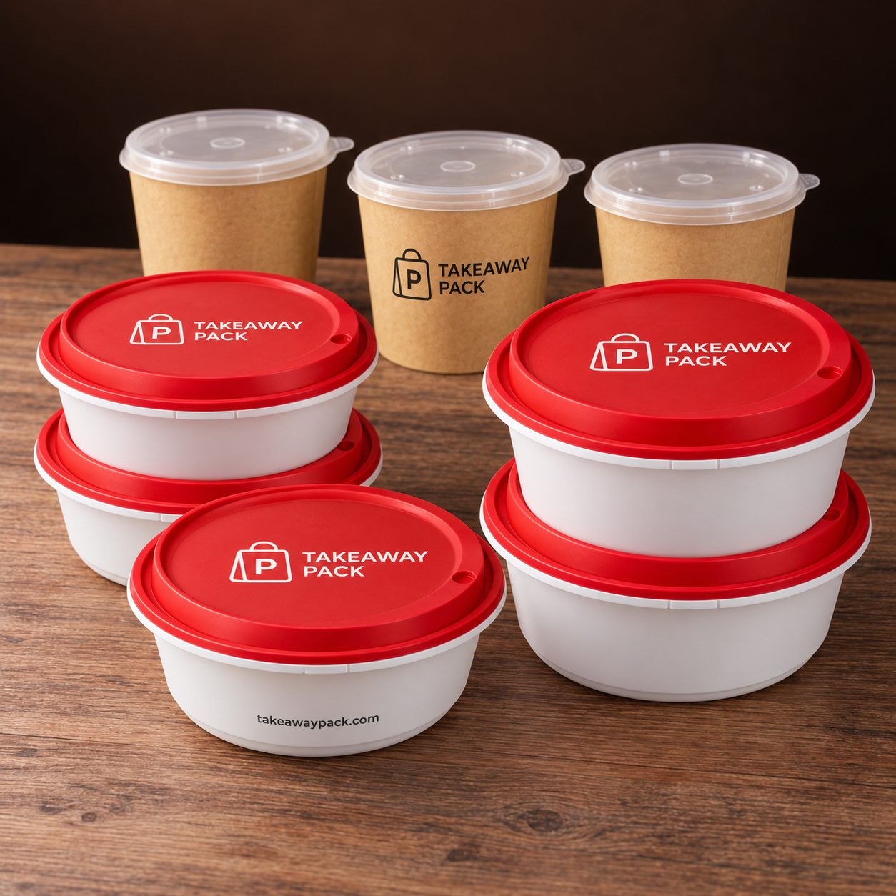 A group of takeout containers printed with a brand name and web address, including round white bowls with red lids, a white bowl with a clear lid, and a brown paper cup.