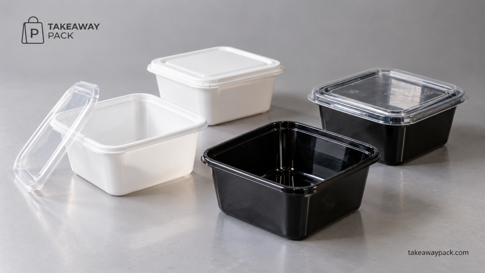 Black and white takeaway containers with clear lids on a grey surface.