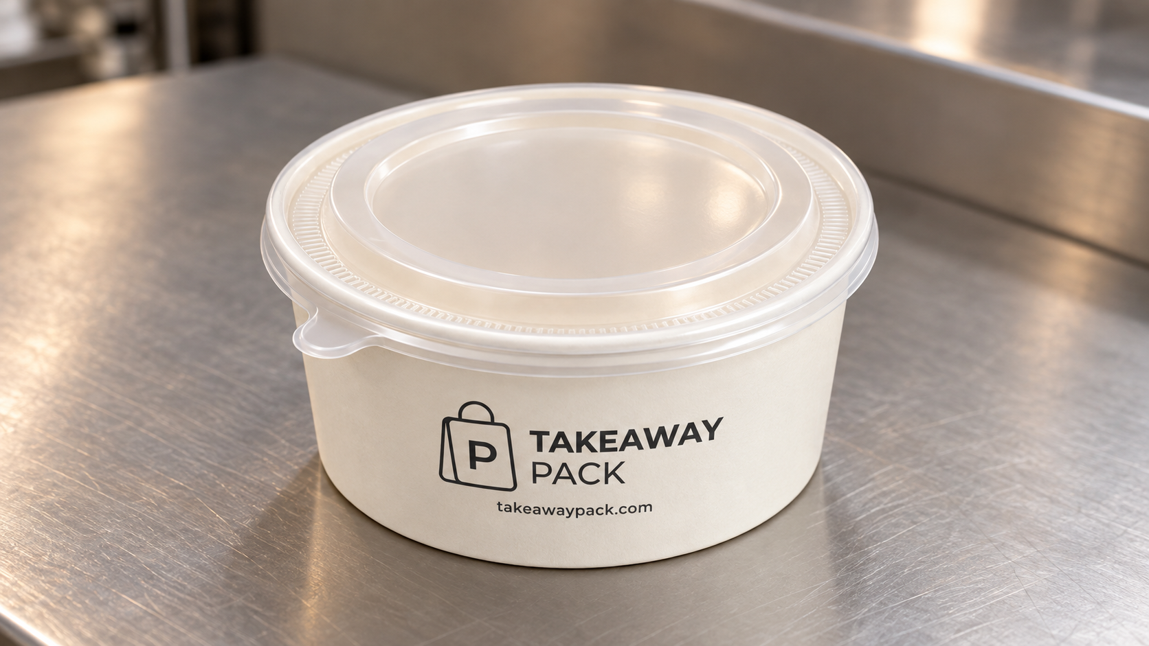Round lidded food container on a metal counter, branded Takeaway Pack.