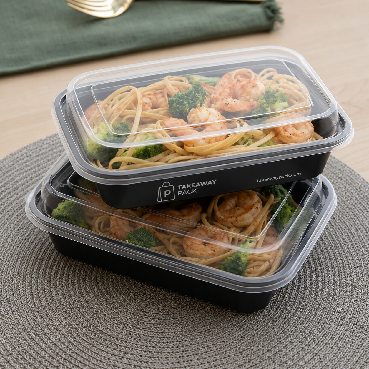 Wrapped disposable cutlery sets and napkins arranged beside takeaway containers