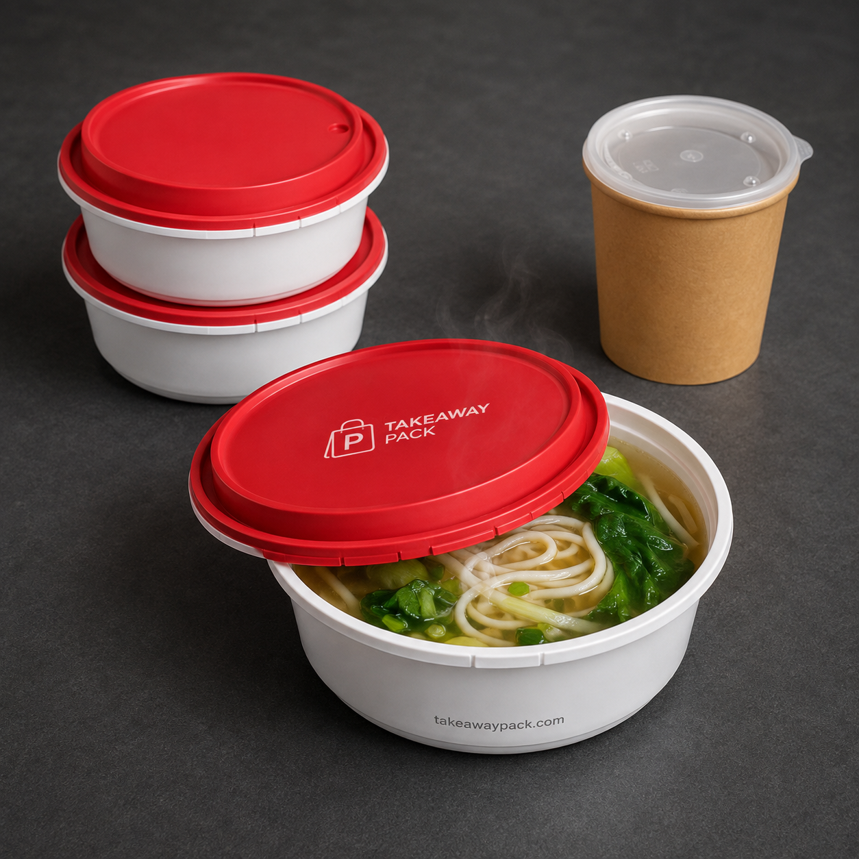 A white bowl of noodles and vegetables with a red branded lid in front, three matching stacked bowls with red lids behind it, and a brown paper cup with a clear lid at right.