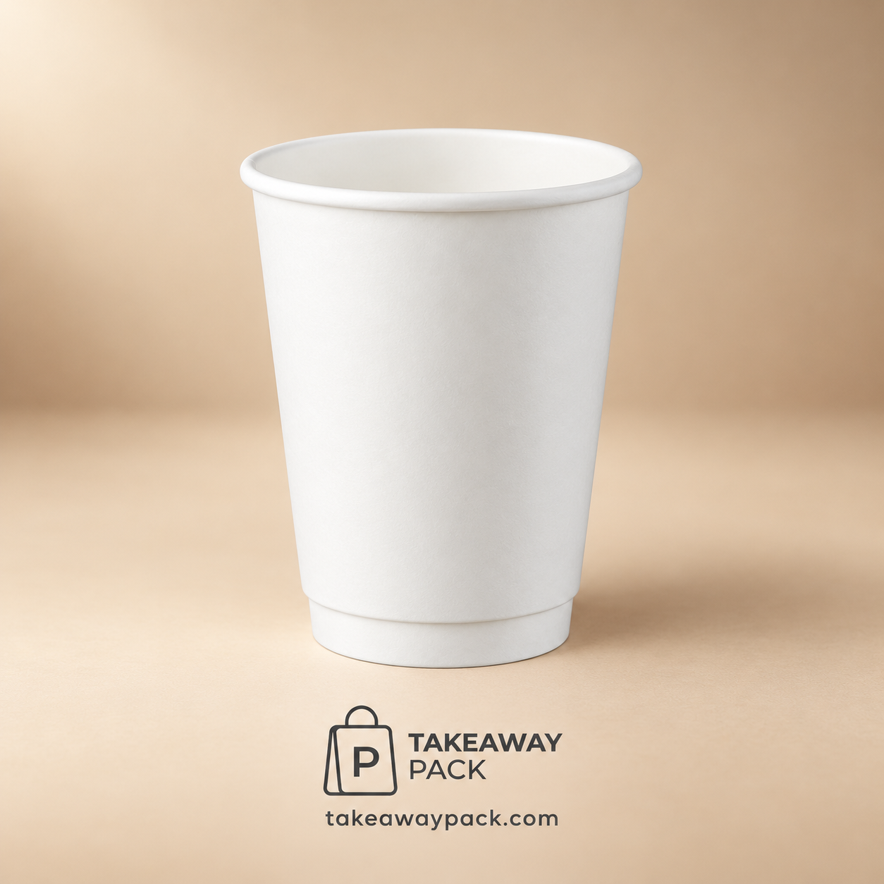White paper cup on a warm beige surface