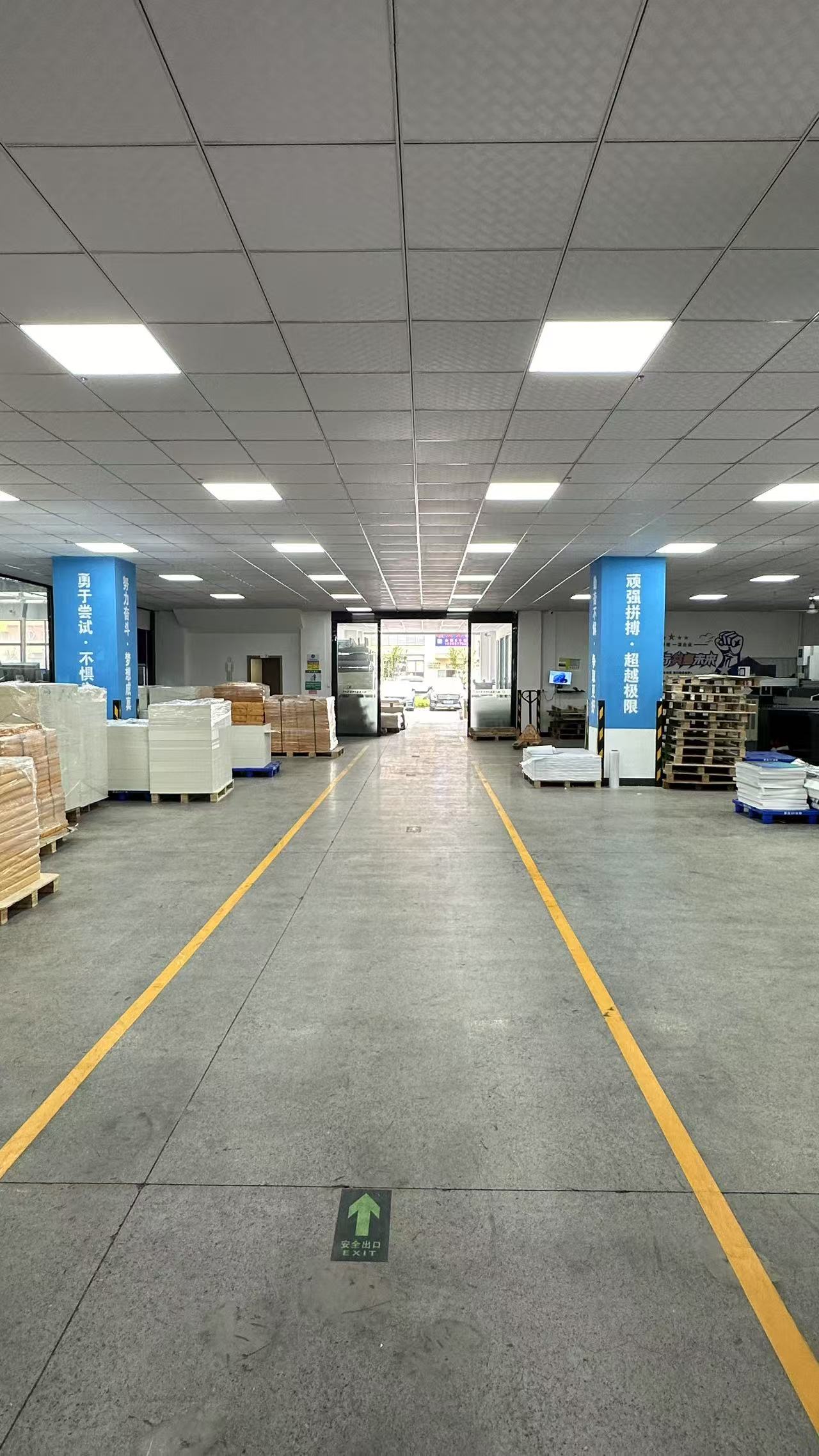 Production floor with material staging and marked access lanes